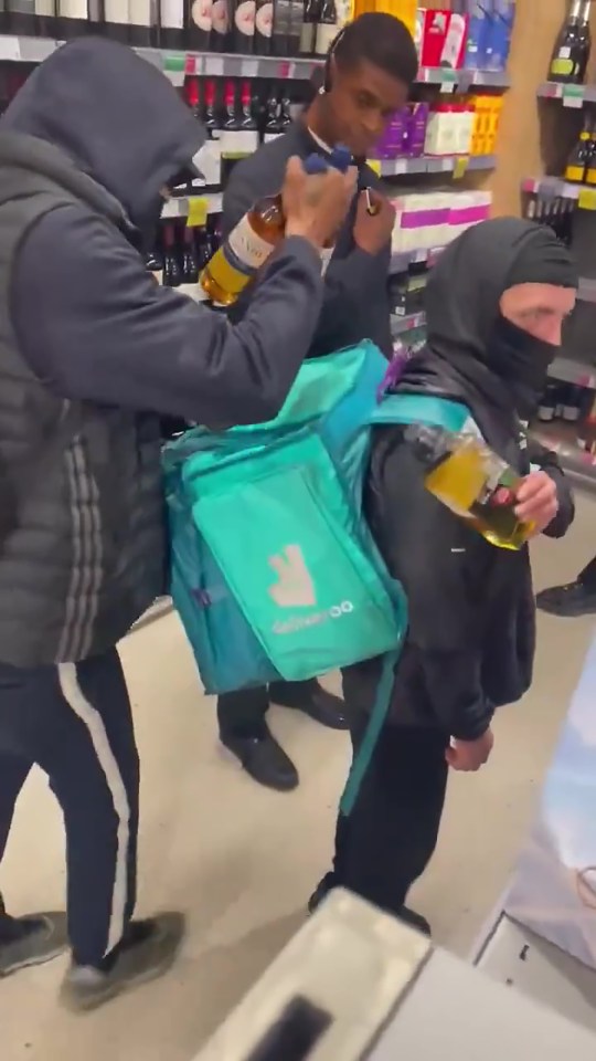 Two people shoplifting alcohol at a Waitrose in Clarkenwell.