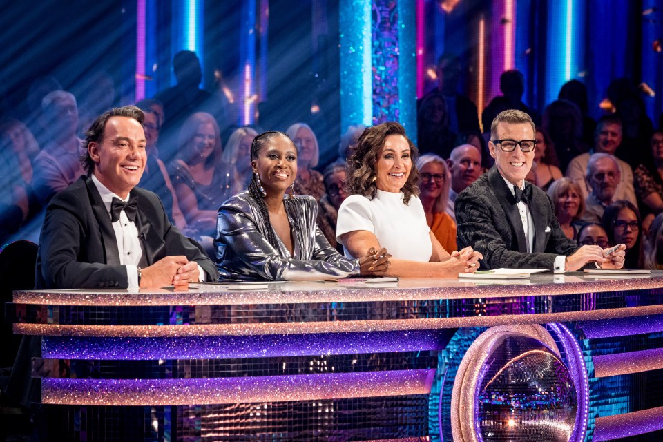Four judges sitting at a glittery desk.