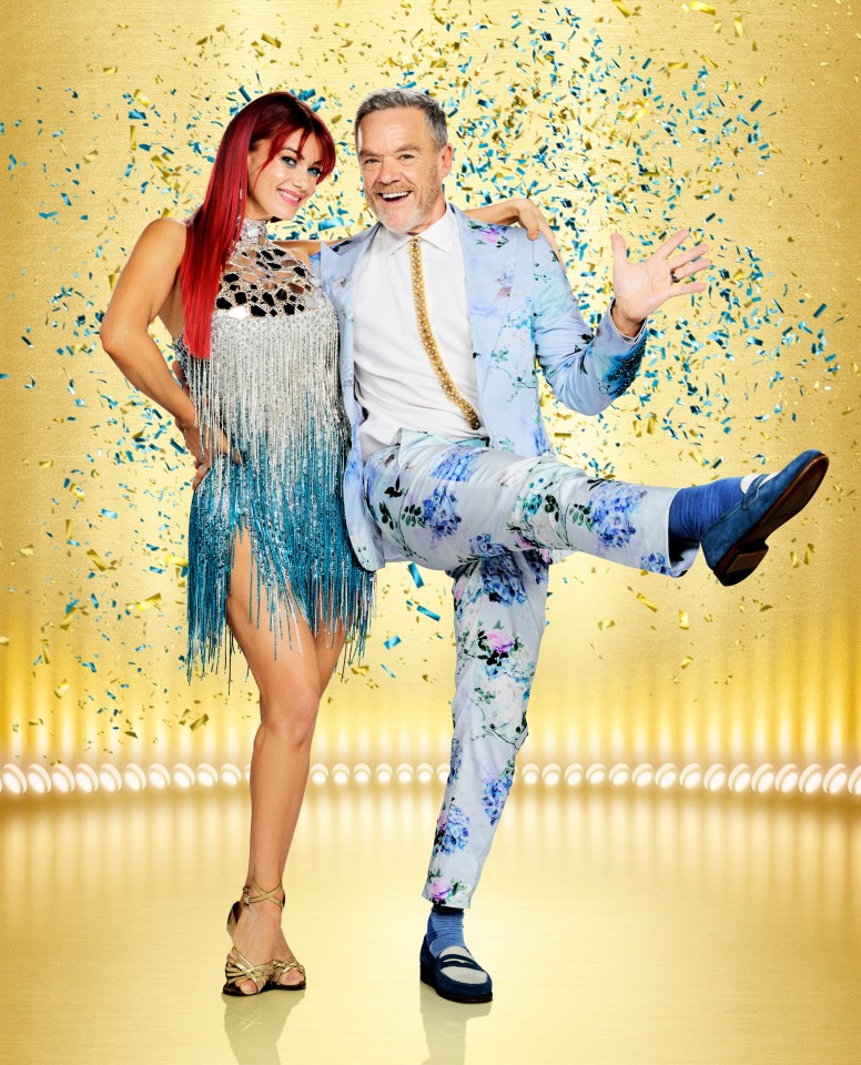 Dianne Buswell and Stefan Dennis smiling at the camera with confetti around them.