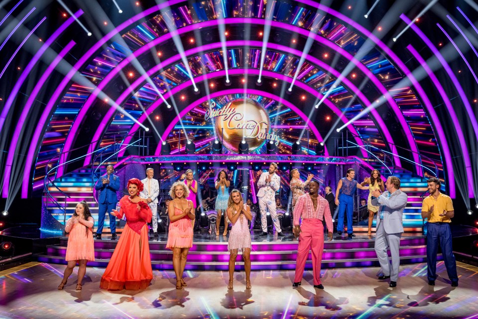 Cast members of Strictly Come Dancing 2025 launch show on stage, smiling and clapping.