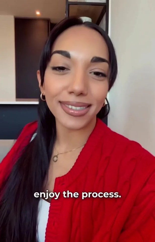 Michelle Tsiakkas smiling and wearing a red cardigan.
