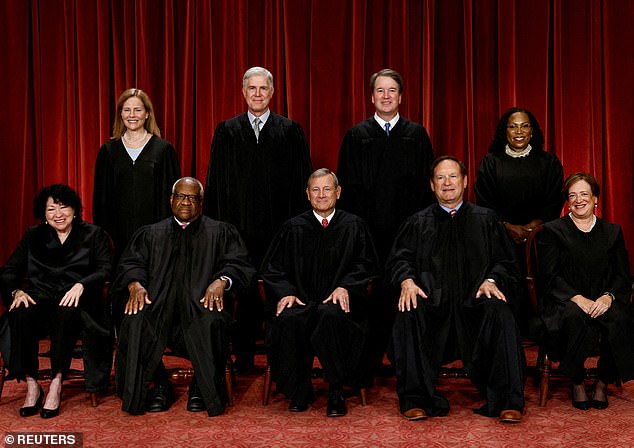 U.S. Supreme Court justices pose for their group portrait at the Supreme Court in Washington