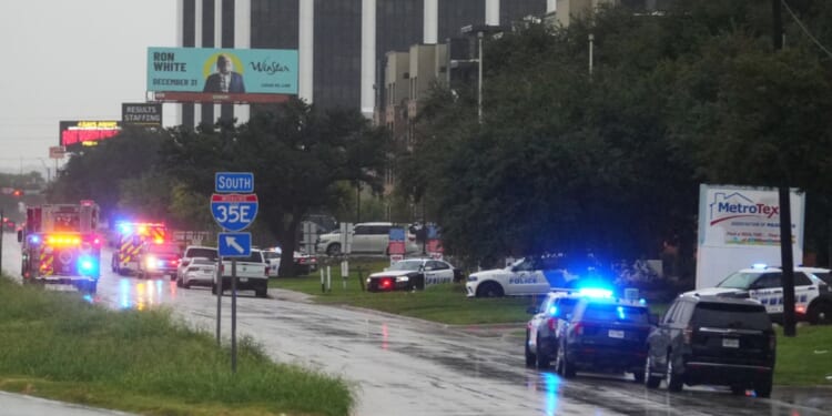Police block off I-35E close to a U.S. Immigration and Customs Enforcement office after a shooting in Dallas, Texas, on Wednesday.