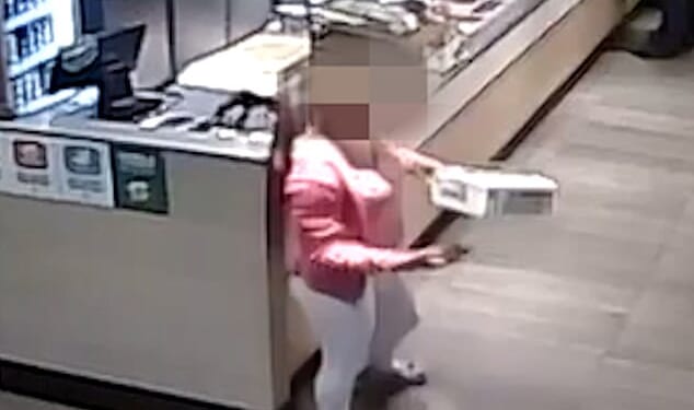 Pictured: One of the thieving teenagers taking an item from Subway. The pack of girls have been accused of attempting to steal from the shop on several occasions