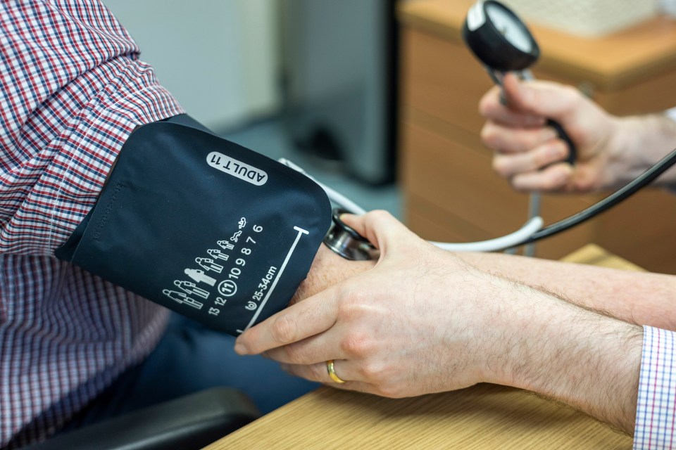 A doctor taking a patient's blood pressure.