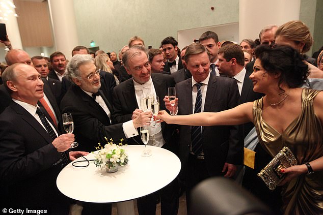 Russian President Vladimir Putin enjoys a drink with Anna Netrebko at the opening of a new theatre in St. Petersburg in 2013
