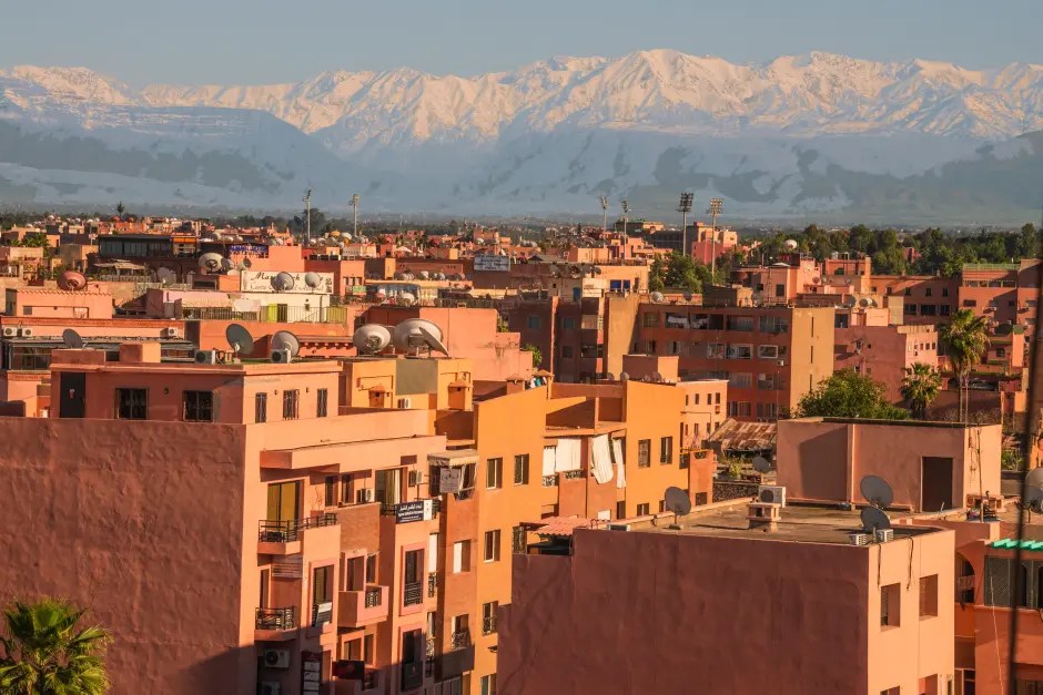 Panoramic view of Marrakesh with the snow-capped Atlas Mountains in the background.