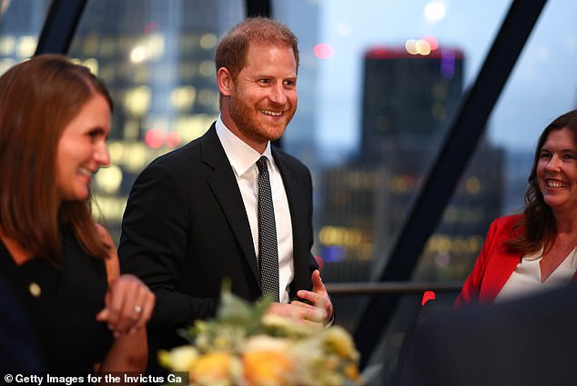 Prince Harry is all smiles as he meets with corporate sponsors and government ministers at a reception for the Invictus Games