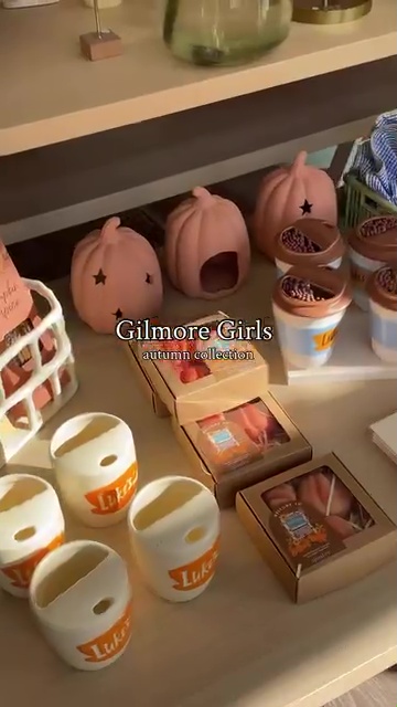 Gilmore Girls autumn collection: pumpkin candle holders and Luke's Diner-themed candles.