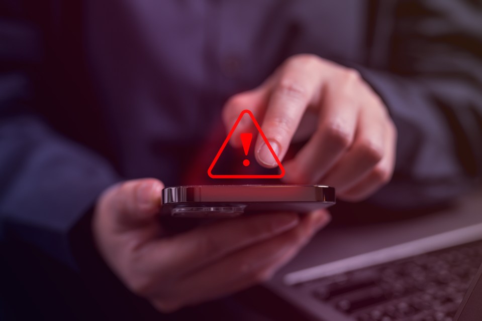Person receiving spam message alert on phone.