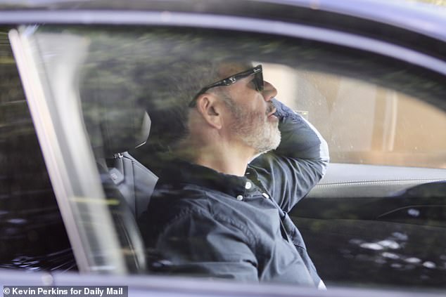 He was spotted for the first time in public on Thursday afternoon, wearing black sunglasses and a navy button down in the drivers seat of his Audi