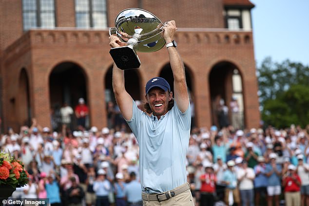 The delighted Englishman lifts the Tour Championship trophy aloft at East Lake, Atlanta