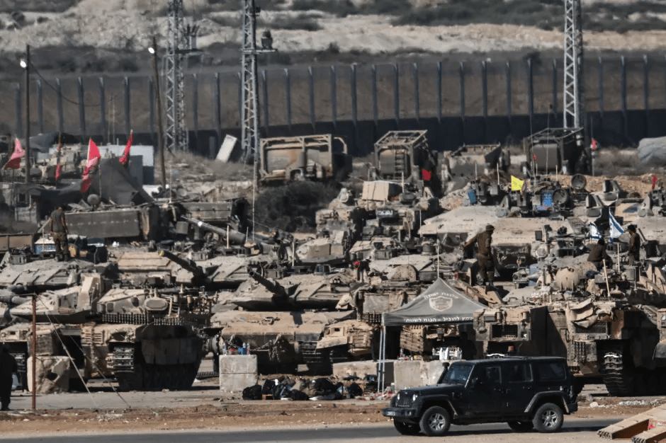 Israeli military tanks and vehicles massed near the Gaza border.