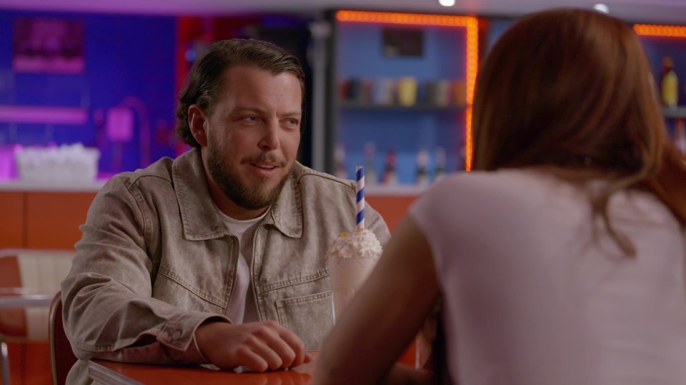 Man and woman having an awkward conversation at a diner.