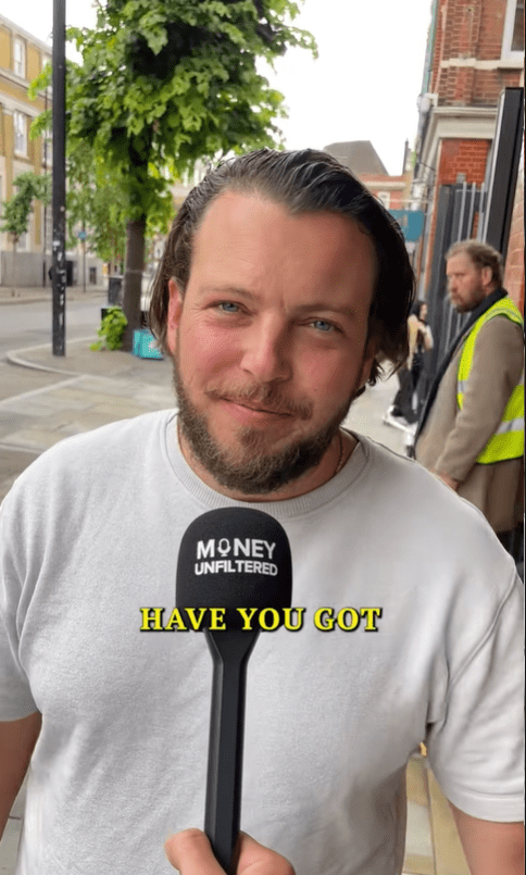 Man holding a microphone labeled "Money Unfiltered" that says "Have you got".