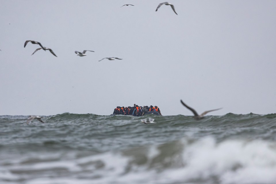Migrants in a small boat crossing the English Channel.