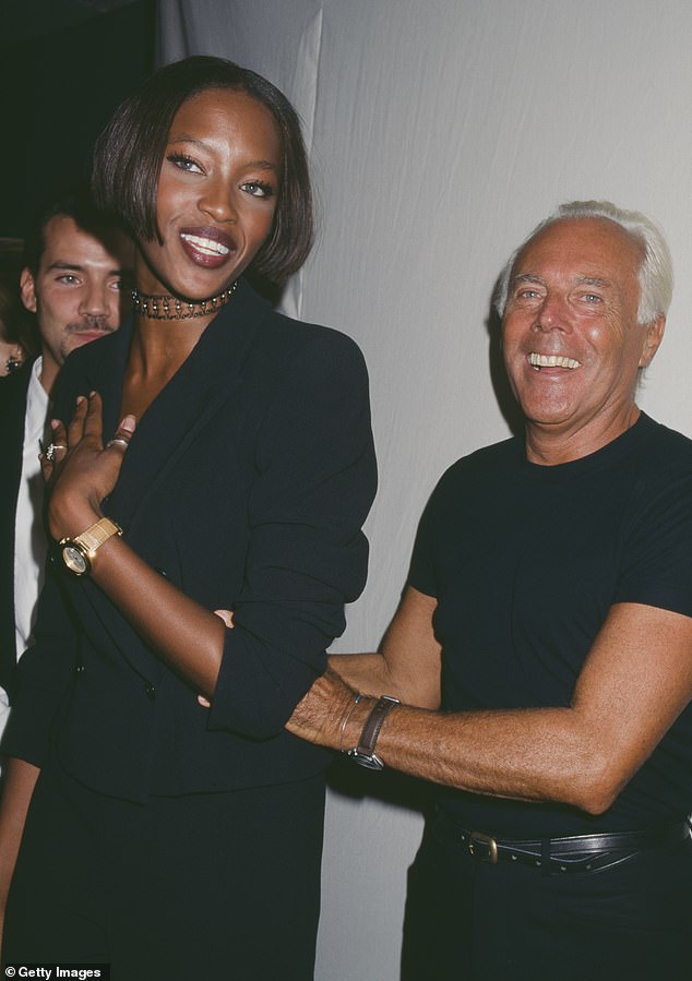 Armani smiles as he attends a private party with model Naomi Campbell in 1996