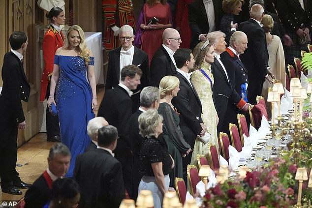 Tiffany Trump (left) walks to her seat alongside Apple's Tim Cook (upper center left) as her husband Michael (center) sits next to Princess Kate