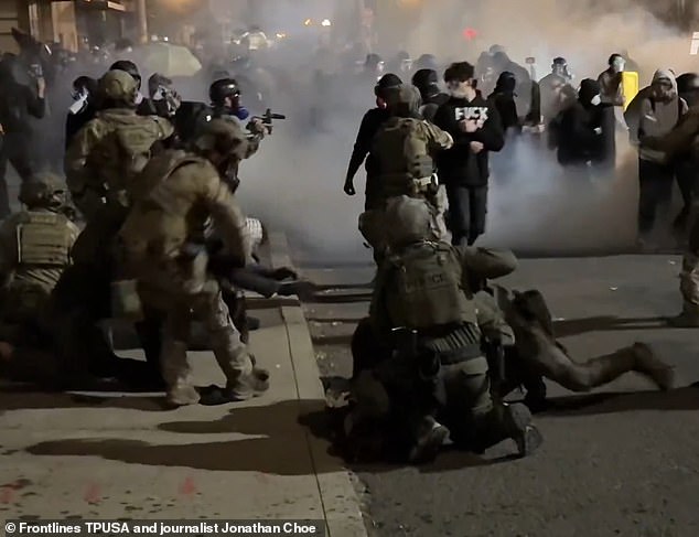 Trump cited far-left individuals protesting and rioting at an ICE facility in the city as the main reason he is sending the military there (Pictured: Police spray tear gas and shoot rubber bullets at protestors blocking the ICE facility on June 18)
