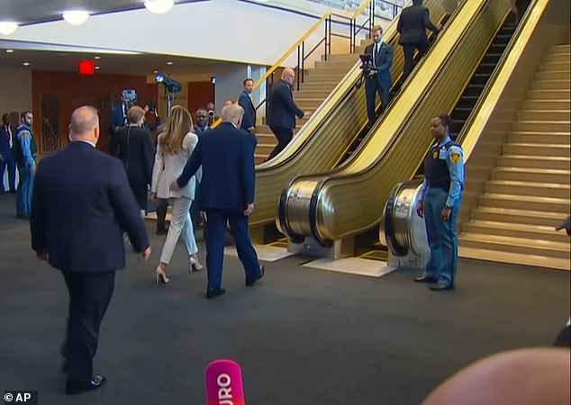 The White House's videographer can be seen riding the escalator backward as he films President Donald Trump and First Lady Melania Trump arriving at the UN. A UN spokesperson said that he may have 'inadvertently triggered the safety function'