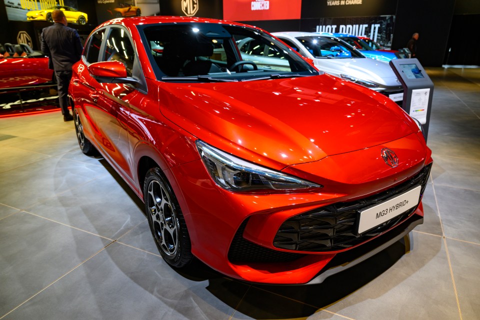 Red MG3 Hybrid+ hatchback on display.