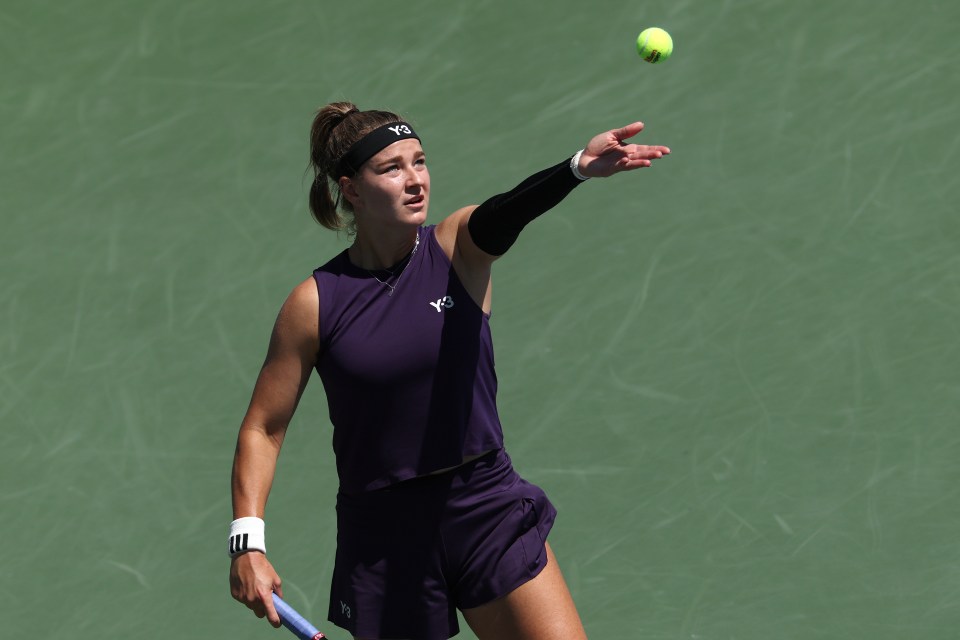 Linda Noskova of Czechia serving a tennis ball.