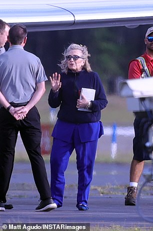 Hillary wore a frumpy sweater pulled over her purple pantsuit