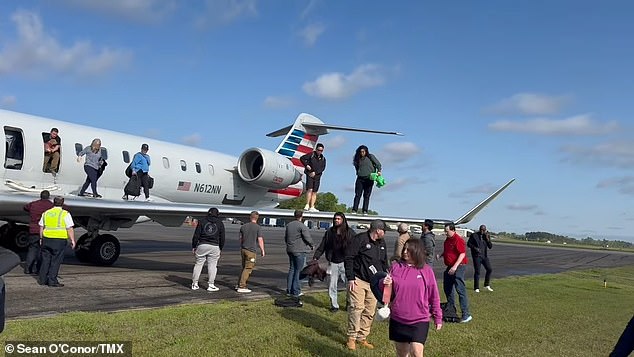 Shocking footage captured by Sean O'Conor, who was onboard the aircraft, showed horrified and confused passengers crawling onto the wings of the plane before jumping a few feet down to the ground