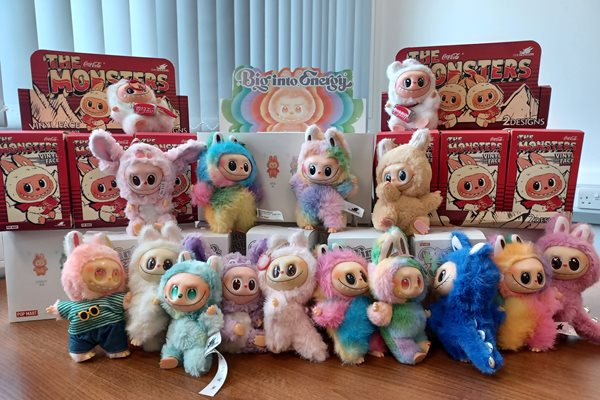 Counterfeit Labubu dolls, some with red packaging labeled "The Monsters."