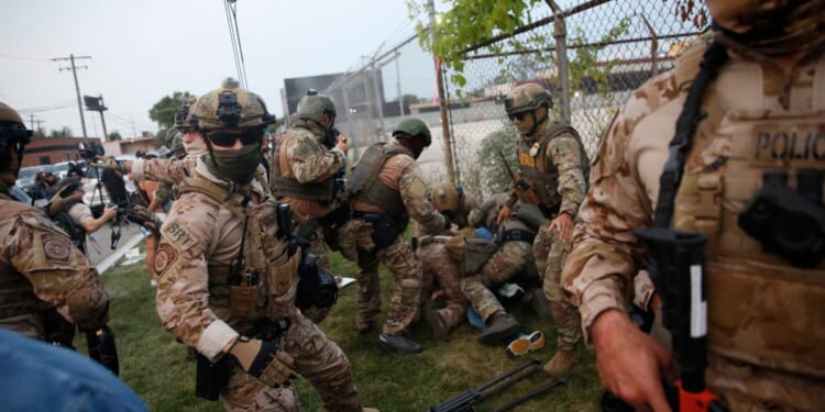 Immigration and Customs Enforcement and Enforcement and Removal Operations agents clash with demonstrators during a protest outside an ICE processing center in Broadview, Illinois, on Sept. 19, 2025.