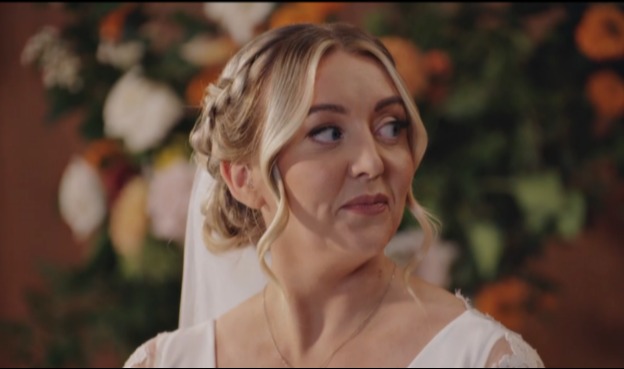 Bride in a white dress looking away.