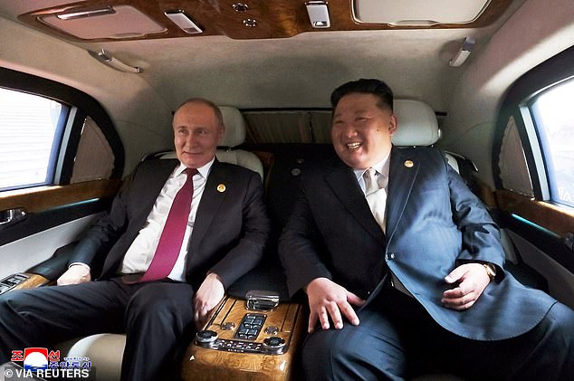 Russian President Vladimir Putin and North Korean leader Kim Jong Un sit in a vehicle during their visit to Beijing to attend China's commemoration of the 80th anniversary of the end of World War Two, in Beijing
