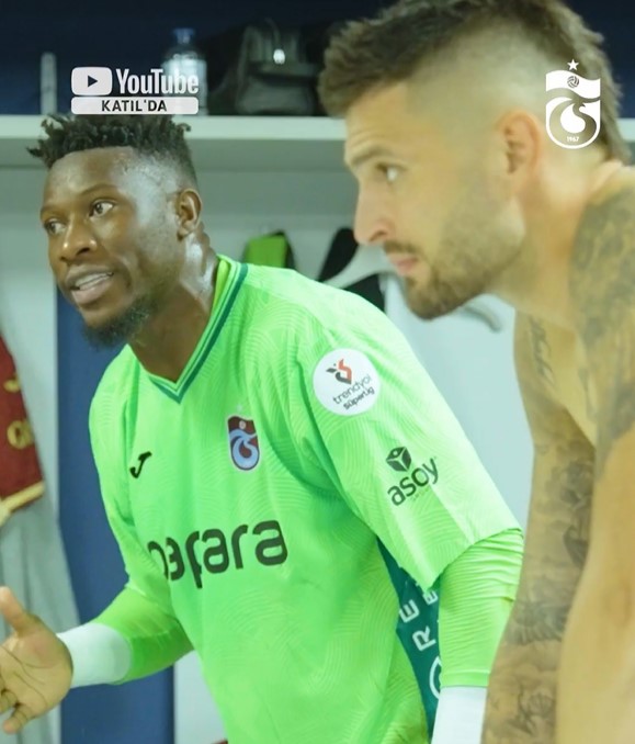 Andre Onana in a green jersey talking to another player.