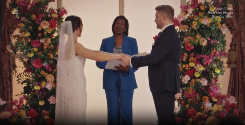 A bride and groom holding hands while being married by an officiant.