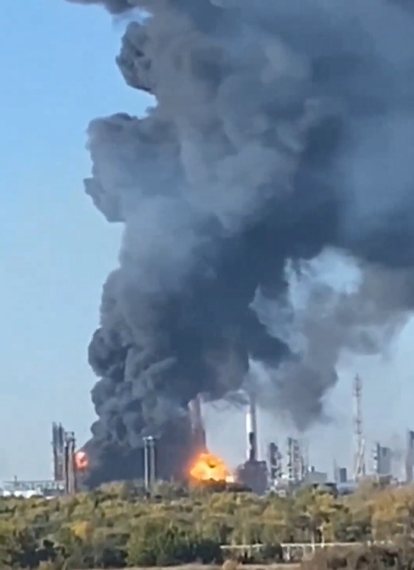 Large plumes of black smoke and fire rise from an industrial plant.