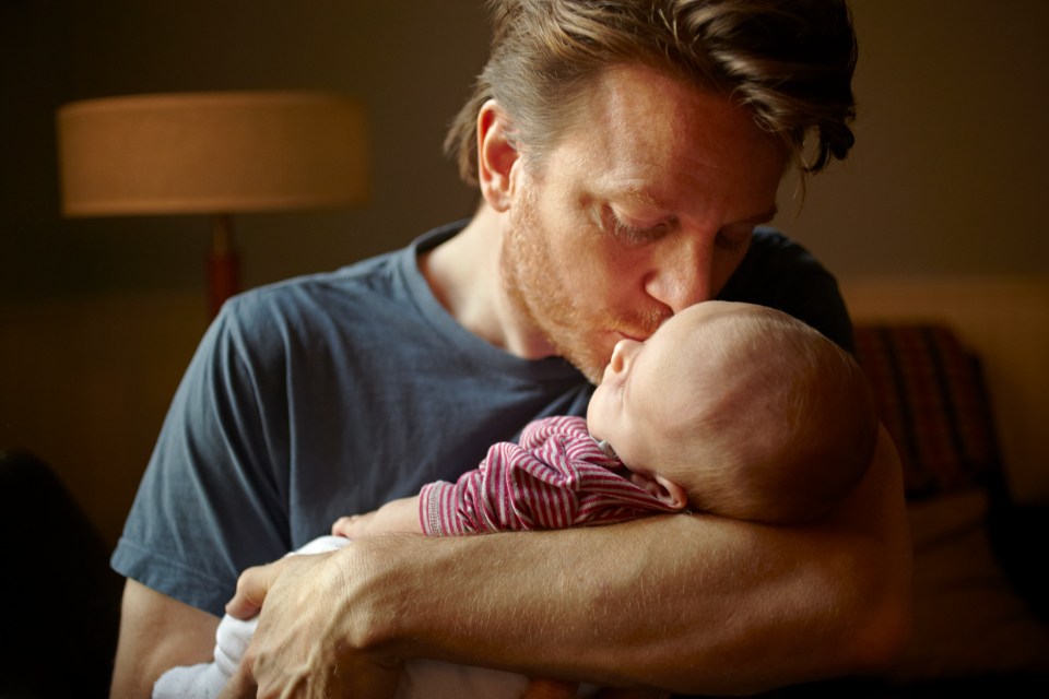 A father and his baby boy in the kitchen.