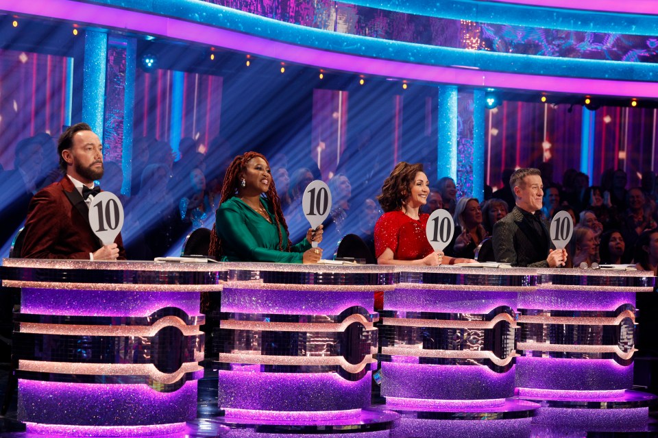 Four Strictly Come Dancing judges, Craig Revel Horwood, Motsi Mabuse, Shirley Ballas, and Anton Du Beke, each hold up a perfect score of 10.