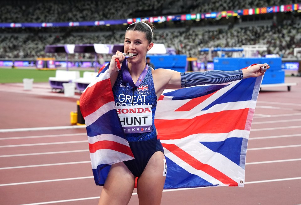 Amy Hunt celebrates winning silver in the Women's 200 metres, holding the British flag.