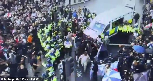 Met Police officers are seen separating crowds of protesters on Saturday afternooon