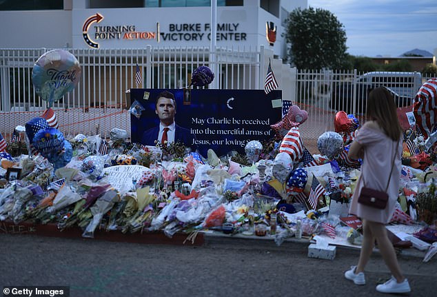 With the country stunned once more by murder - this time of the conservative activist Charlie Kirk - and with President Donald Trump visiting her husband's homeland, Meghan's relative silence may speak volumes (Pictured: Memorial to Kirk in Phoenix, Arizona)