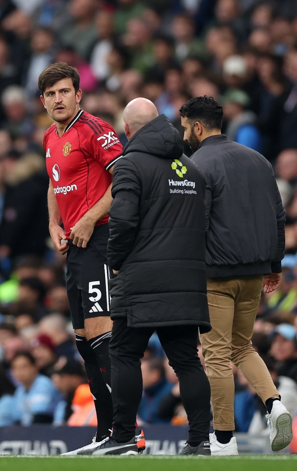 Manchester United player Harry Maguire enters the pitch under manager Ruben Amorim's supervision.