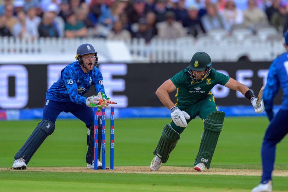 Jos Buttler attempting a stumping of Aiden Markram during a cricket match.