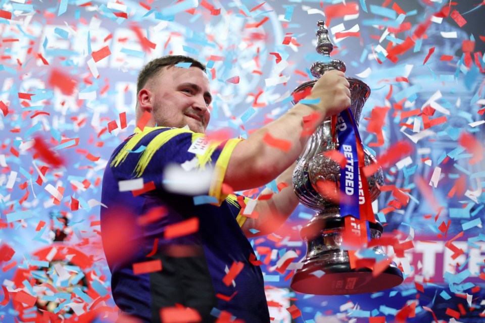 BLACKPOOL, ENGLAND - JULY 27: Luke Littler of England celebrates with The Phil Taylor Trophy after victory in the Final match between James Wade of England and Luke Littler of England on day nine of the 2025 Betfred World Matchplay at Winter Gardens on July 27, 2025 in Blackpool, England. (Photo by Lewis Storey/Getty Images)