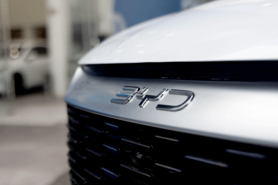 Close-up of a "340" car badge.