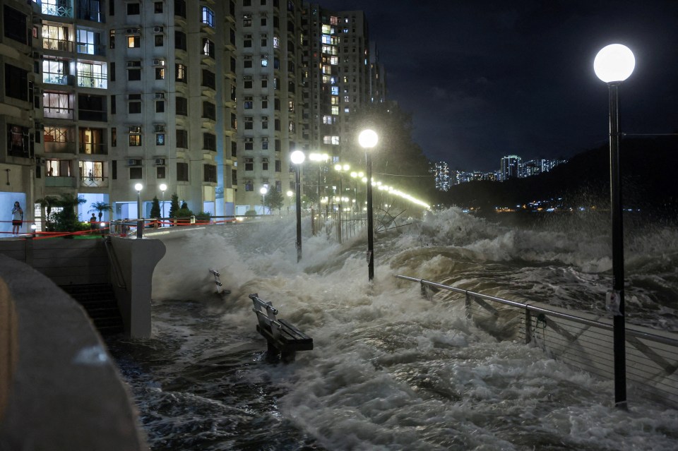 Waves from Super Typhoon Ragasa crash onto chairs by the shore in Hong Kong.