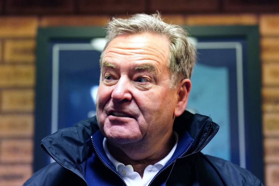 Broadcaster Jeff Stelling wearing a dark blue jacket and white polo shirt.