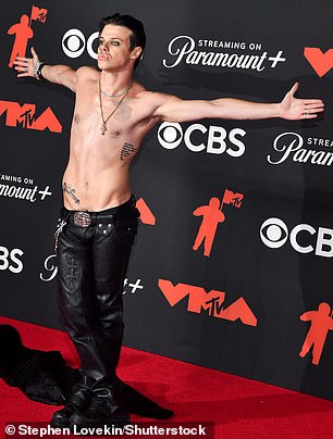 He walked with attitude on the red carpet before turning to the cameras with both arms outstretched