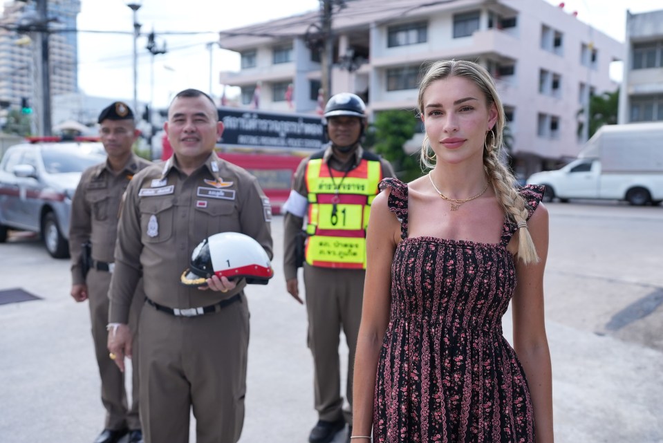 Woman standing with Phuket Provincial police officers.