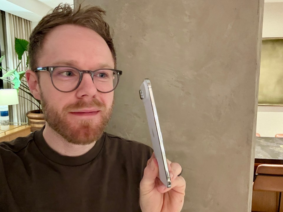 Man holding a white iPhone.