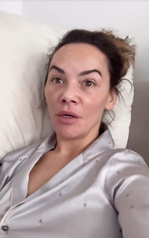 Chelsee Healey lying in bed wearing a silver pajama top with small star patterns.